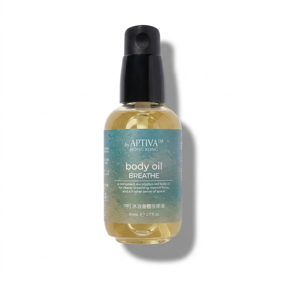 A bottle of APTIVA BREATHE body oil by By Apthiva Hong Kong, featuring a black spray pump and a translucent teal label over a golden-yellow oil, set against a plain white background with a soft shadow.